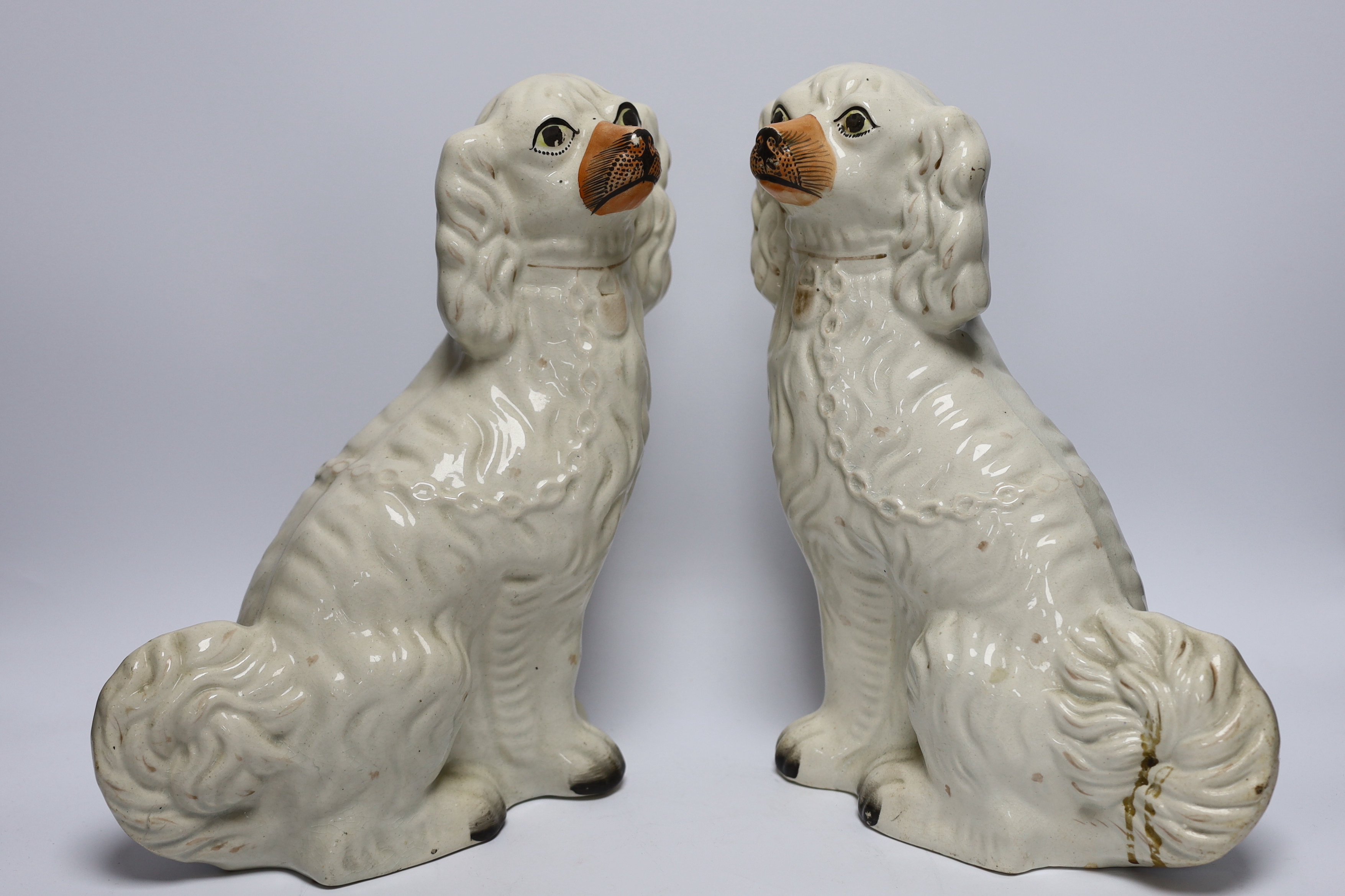 A mixed collection of Staffordshire figure groups to include various spaniels, a Prince Albert figure, courting couples and other bocage groups